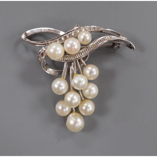 1882 - A modern 14k and graduated eleven stone cultured pearl cluster set brooch, 40mm, gross weight 7.4 gr... 