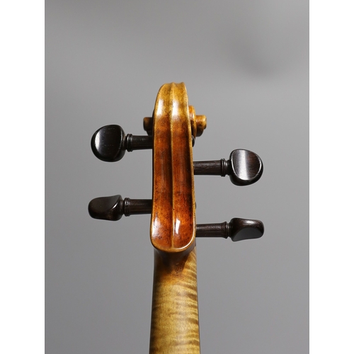 1283 - A 19th century violin labelled JB Guadagnini, back measures 35cm, with two bows, one silver-mounted.... 