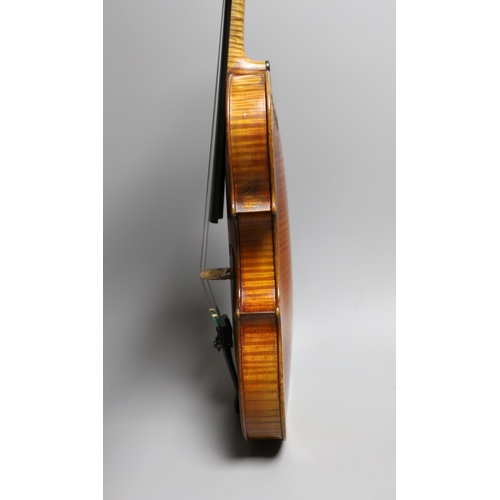 1283 - A 19th century violin labelled JB Guadagnini, back measures 35cm, with two bows, one silver-mounted.... 