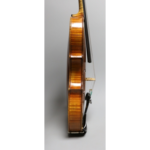 1283 - A 19th century violin labelled JB Guadagnini, back measures 35cm, with two bows, one silver-mounted.... 