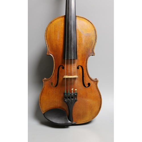 1283 - A 19th century violin labelled JB Guadagnini, back measures 35cm, with two bows, one silver-mounted.... 