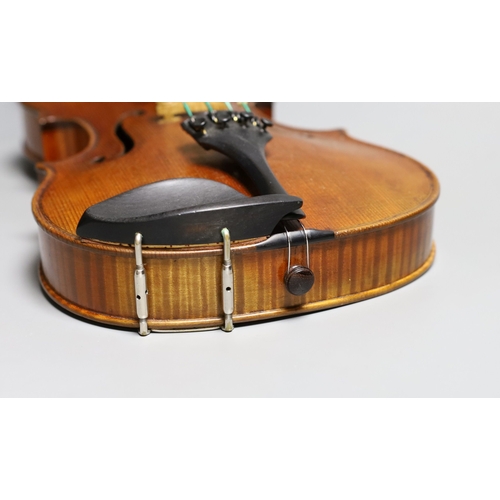 1283 - A 19th century violin labelled JB Guadagnini, back measures 35cm, with two bows, one silver-mounted.... 