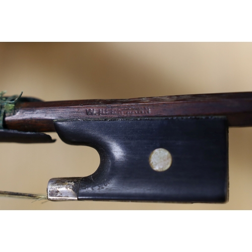 1283 - A 19th century violin labelled JB Guadagnini, back measures 35cm, with two bows, one silver-mounted.... 