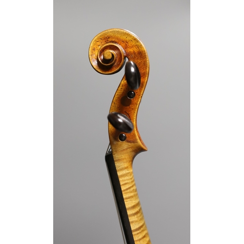 1283 - A 19th century violin labelled JB Guadagnini, back measures 35cm, with two bows, one silver-mounted.... 