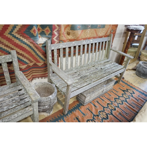 121 - A near pair of weathered slatted teak garden benches, larger length 155cm, depth 56cm, height 90cm... 