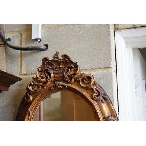 135 - A Victorian giltwood and gesso oval girandole, width 48cm, height 72cm