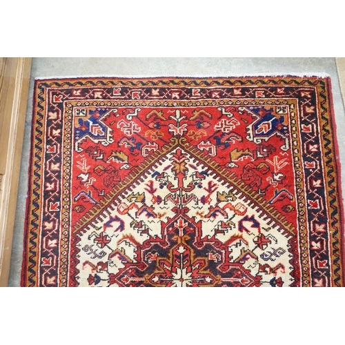 143 - A Heriz ivory ground rug, 148 x 110cm