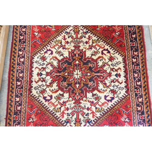 143 - A Heriz ivory ground rug, 148 x 110cm