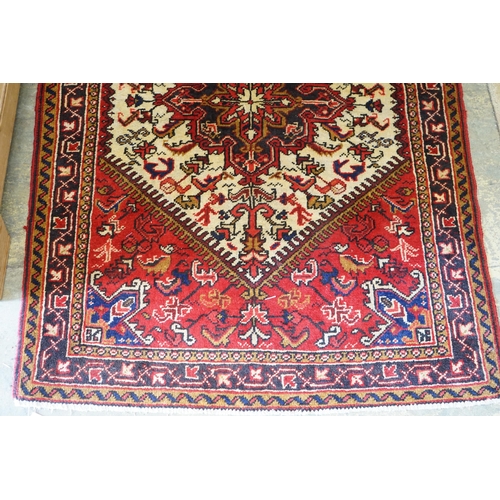 143 - A Heriz ivory ground rug, 148 x 110cm