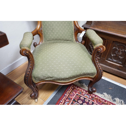 170 - A Victorian walnut spoon back open armchair