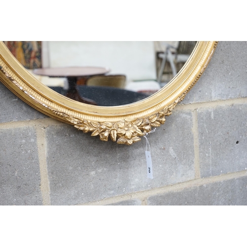 20 - An early 20th century gilt wood and gesso oval wall mirror width 75cm height 96cm.