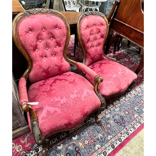 26 - A pair of Victorian walnut spoon back upholstered chairs, one with arms