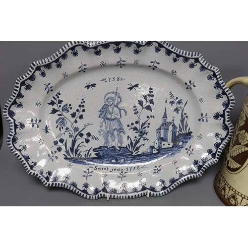 282 - A Brannum sgraffito jug and a French faience serving dish, 42cm