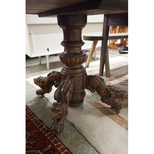 48 - An early 20th century Continental carved oak circular centre table with heraldic tapestry top on win... 