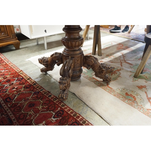 48 - An early 20th century Continental carved oak circular centre table with heraldic tapestry top on win... 