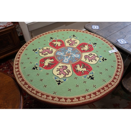 48 - An early 20th century Continental carved oak circular centre table with heraldic tapestry top on win... 