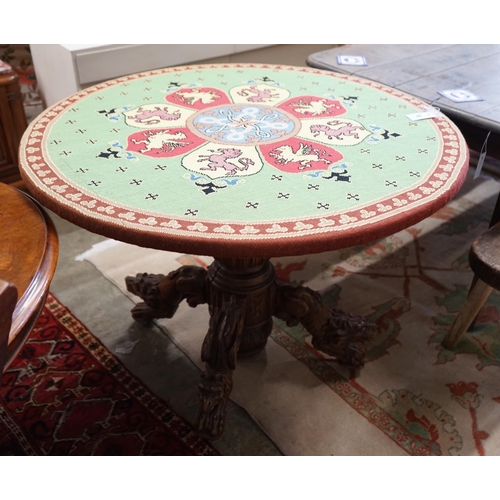 48 - An early 20th century Continental carved oak circular centre table with heraldic tapestry top on win... 