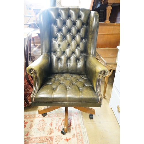 53 - A Victorian style buttoned green leather swivel desk wing armchair, width 78cm, height 120cm