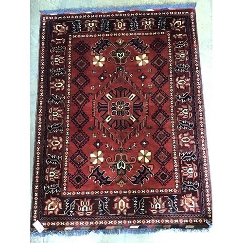 68 - A Caucasian geometric red ground rug, 150 x 115cm