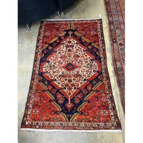 77 - A Persian red ground rug, 196 x 123cm