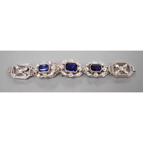 974 - A modern 9ct white metal and three stone emerald cut synthetic sapphire set pierced link bracelet, a... 