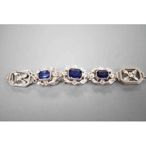 974 - A modern 9ct white metal and three stone emerald cut synthetic sapphire set pierced link bracelet, a... 