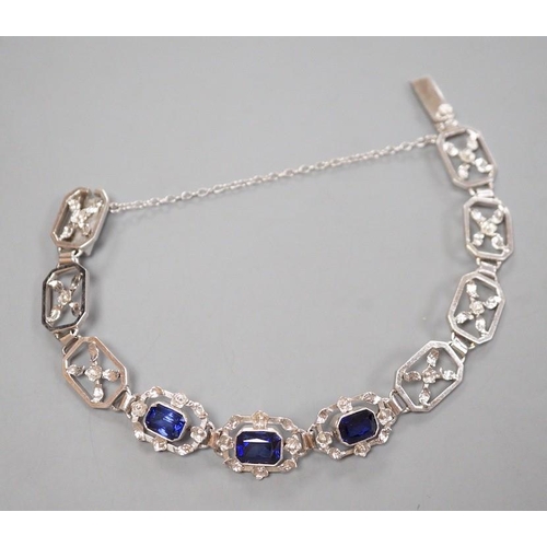 974 - A modern 9ct white metal and three stone emerald cut synthetic sapphire set pierced link bracelet, a... 