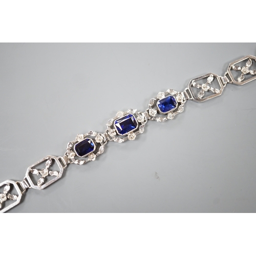 974 - A modern 9ct white metal and three stone emerald cut synthetic sapphire set pierced link bracelet, a... 