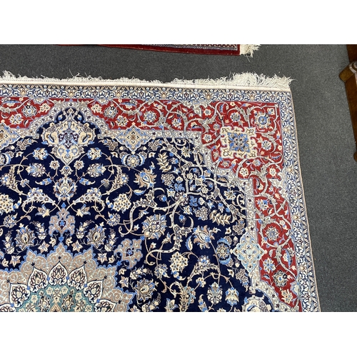 197 - A North West Persian blue ground part silk rug, 220 x 217cm together with a similar smaller red grou... 