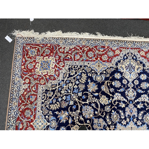 197 - A North West Persian blue ground part silk rug, 220 x 217cm together with a similar smaller red grou... 