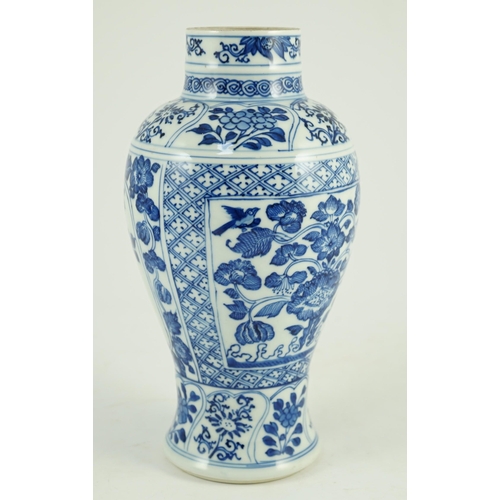 105 - A Chinese blue and white vase, Kangxi period, painted with birds amid flowers and rockwork, within f... 