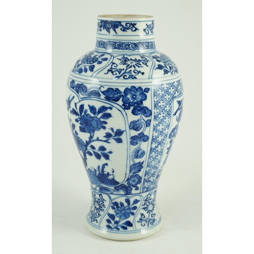 105 - A Chinese blue and white vase, Kangxi period, painted with birds amid flowers and rockwork, within f... 