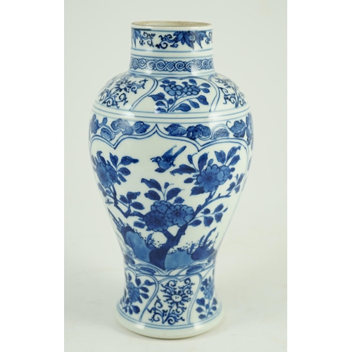 105 - A Chinese blue and white vase, Kangxi period, painted with birds amid flowers and rockwork, within f... 