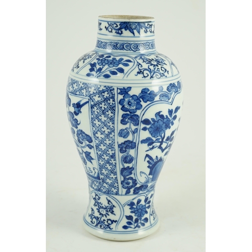 105 - A Chinese blue and white vase, Kangxi period, painted with birds amid flowers and rockwork, within f... 