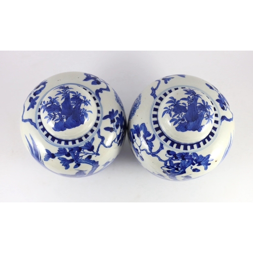 107 - A pair of Chinese blue and white jars and covers, 19th century, each painted with pheasants amid peo... 