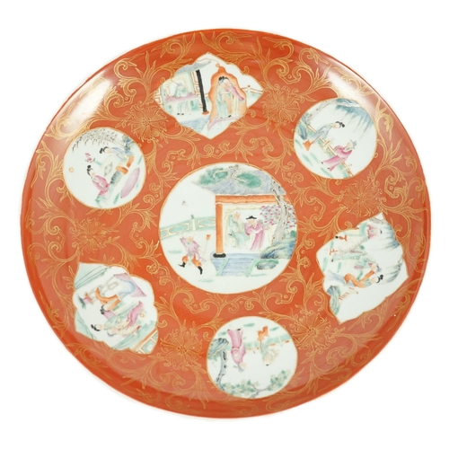 129 - A Chinese coral ground dish, Qianlong seal mark but Republic period, painted in famille rose fencai ... 