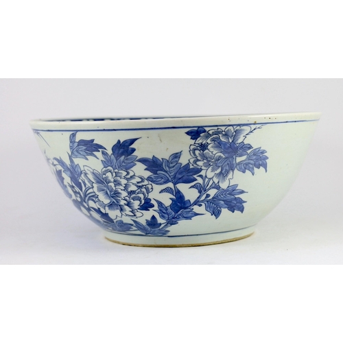 132 - A large Chinese blue and white bowl, 19th century, the interior painted with a bird amid flowers roc... 