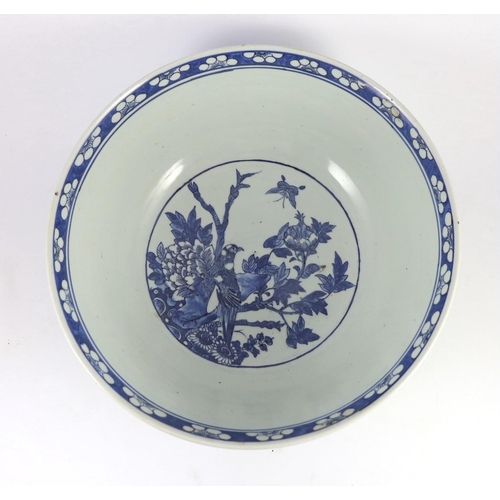 132 - A large Chinese blue and white bowl, 19th century, the interior painted with a bird amid flowers roc... 