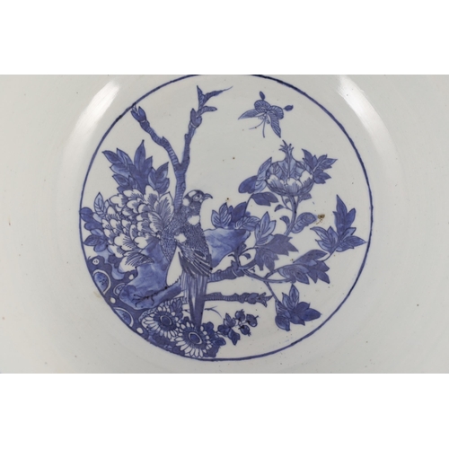 132 - A large Chinese blue and white bowl, 19th century, the interior painted with a bird amid flowers roc... 