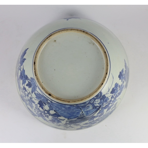 132 - A large Chinese blue and white bowl, 19th century, the interior painted with a bird amid flowers roc... 