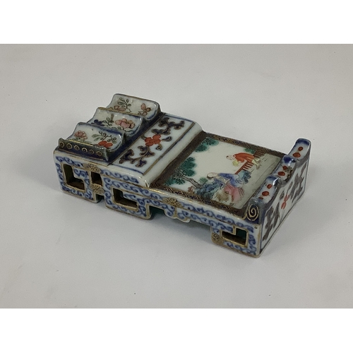 135 - A small Chinese enamelled porcelain brushrest, Jiaqing mark and period (1796-1820), finely painted w... 