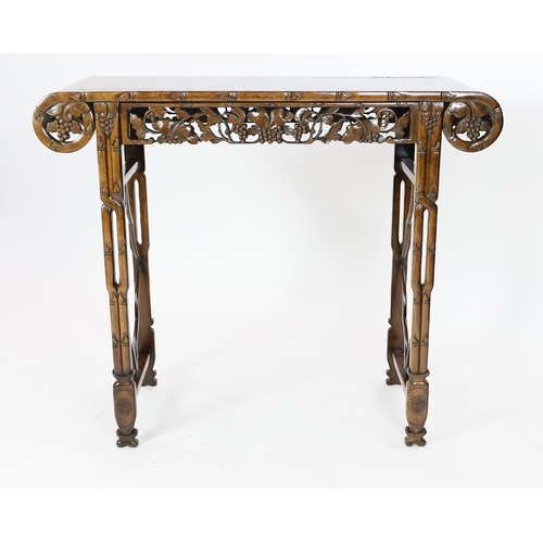 140 - A Chinese hardwood altar table, 20th century, the rectangular top with rounded ends, above a fruitin... 