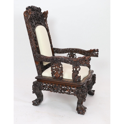 143 - A good Chinese hongmu dragon throne armchair, c.1900, carved in high relief and open work with con... 