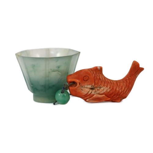 150 - A Chinese jadeite small cup and a coral 'fish' pendant, 19th/20th century, the octagonal cup with fl... 