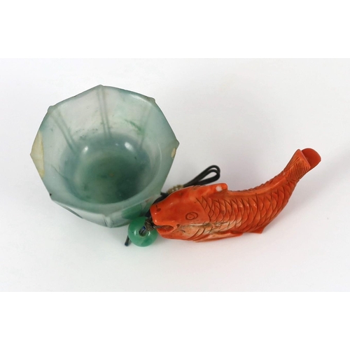 150 - A Chinese jadeite small cup and a coral 'fish' pendant, 19th/20th century, the octagonal cup with fl... 