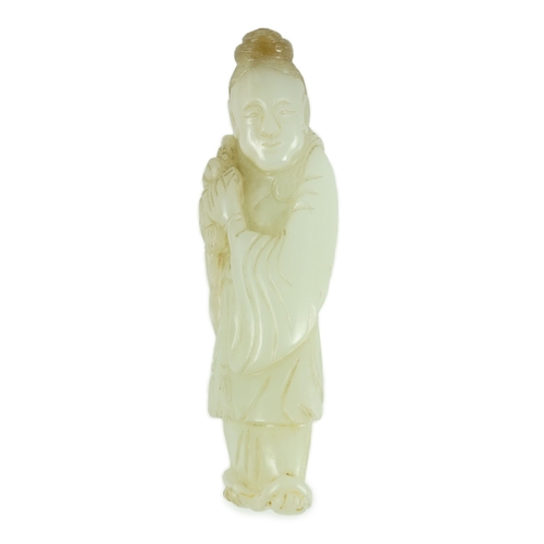 151 - A Chinese pale celadon jade figure of a lady, possibly He Xiangu, 19th century, the carver skilfully... 