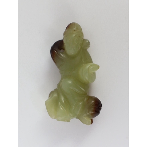 152 - A Chinese yellow and brown jade figure of a man seated on a creature, 19th century, the greenish yel... 