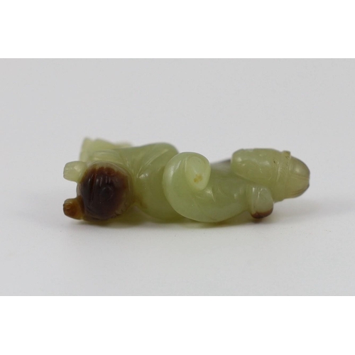 152 - A Chinese yellow and brown jade figure of a man seated on a creature, 19th century, the greenish yel... 