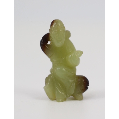 152 - A Chinese yellow and brown jade figure of a man seated on a creature, 19th century, the greenish yel... 