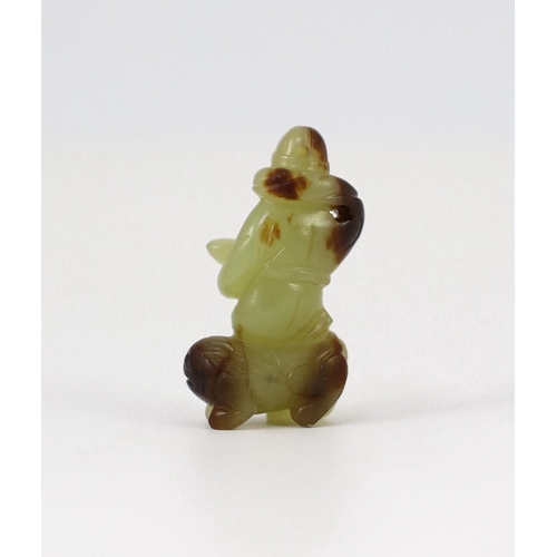 152 - A Chinese yellow and brown jade figure of a man seated on a creature, 19th century, the greenish yel... 